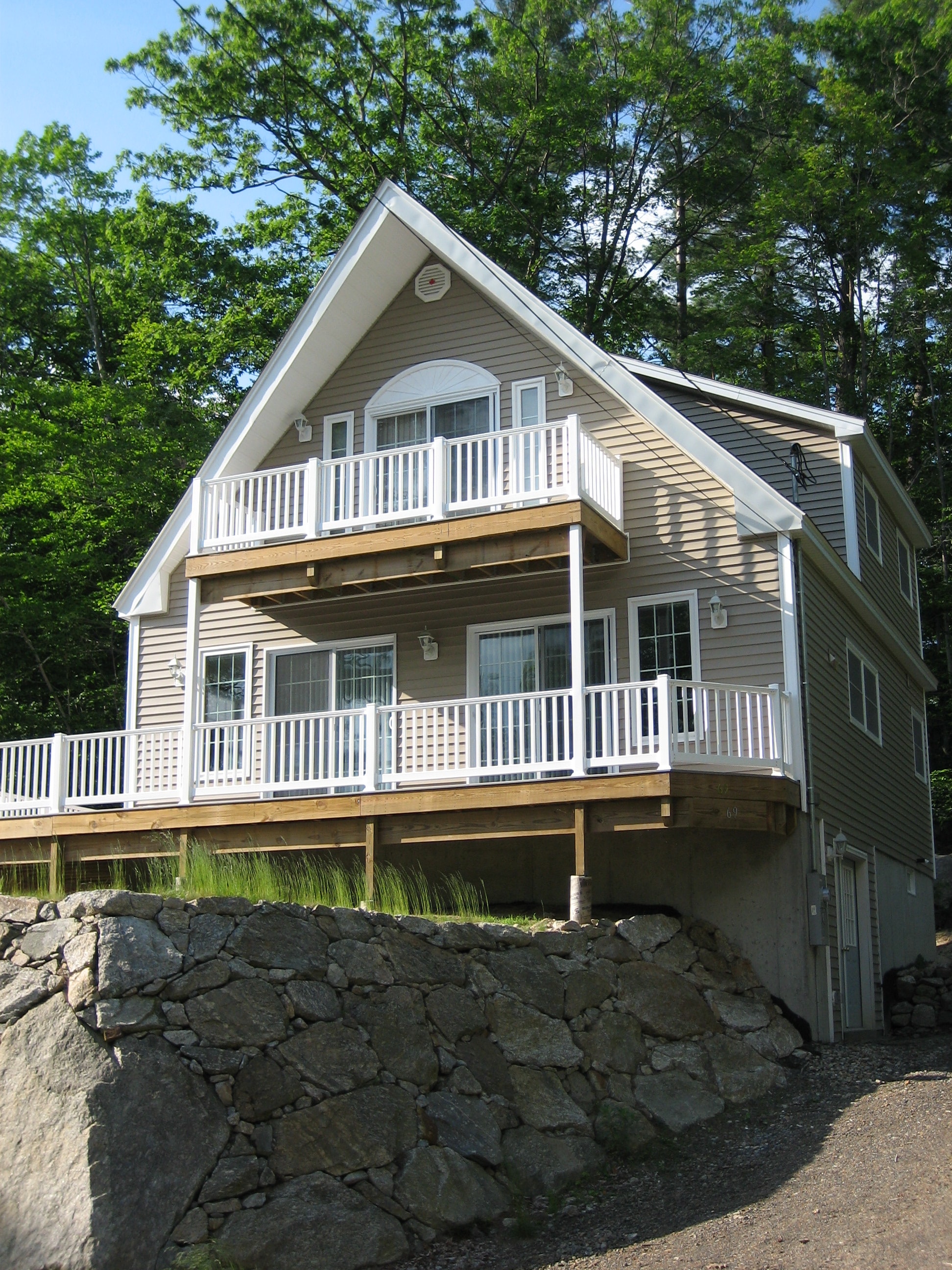 Borrus Chalet with white railings and stone wall