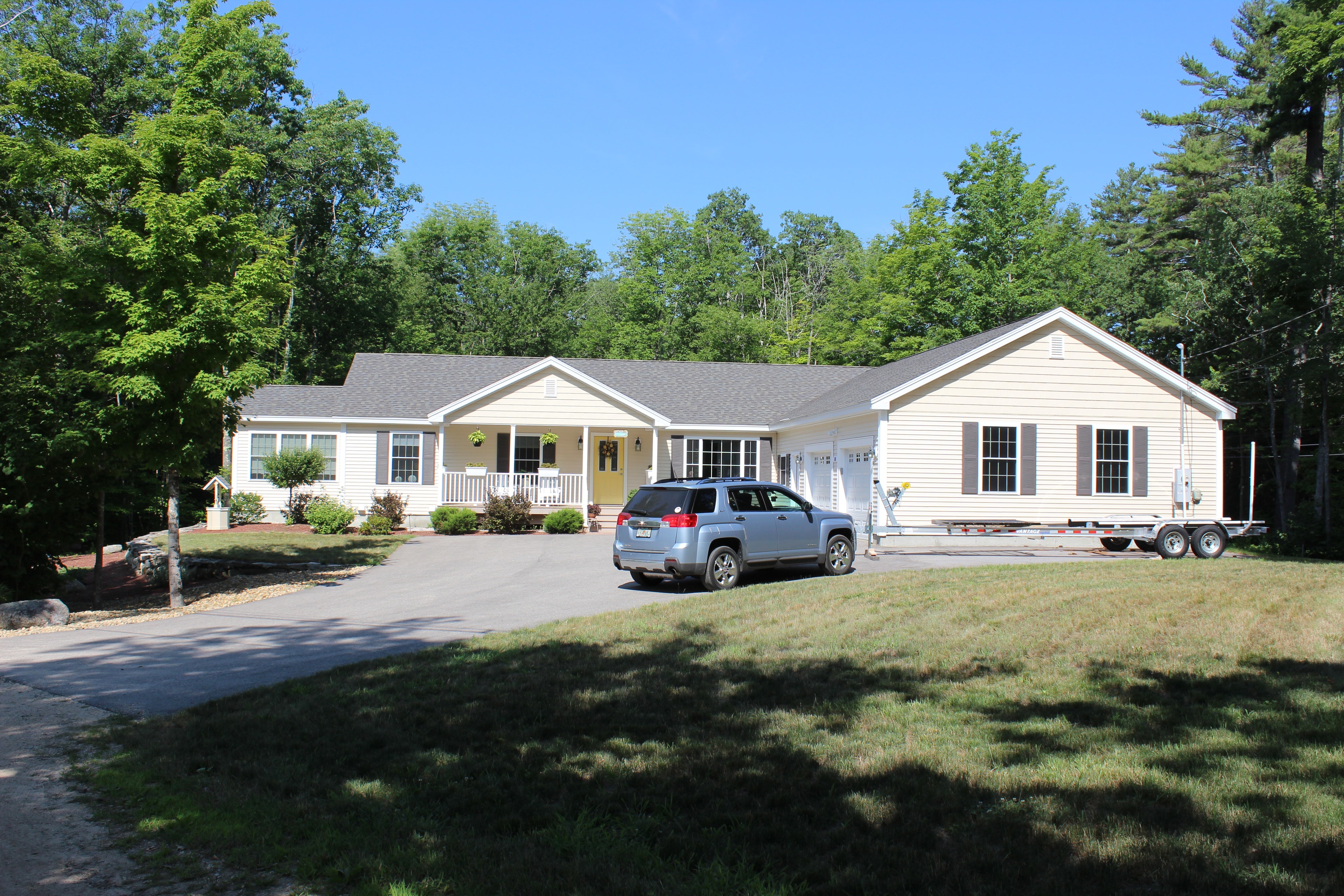 Schurman home with white siding and yellow door