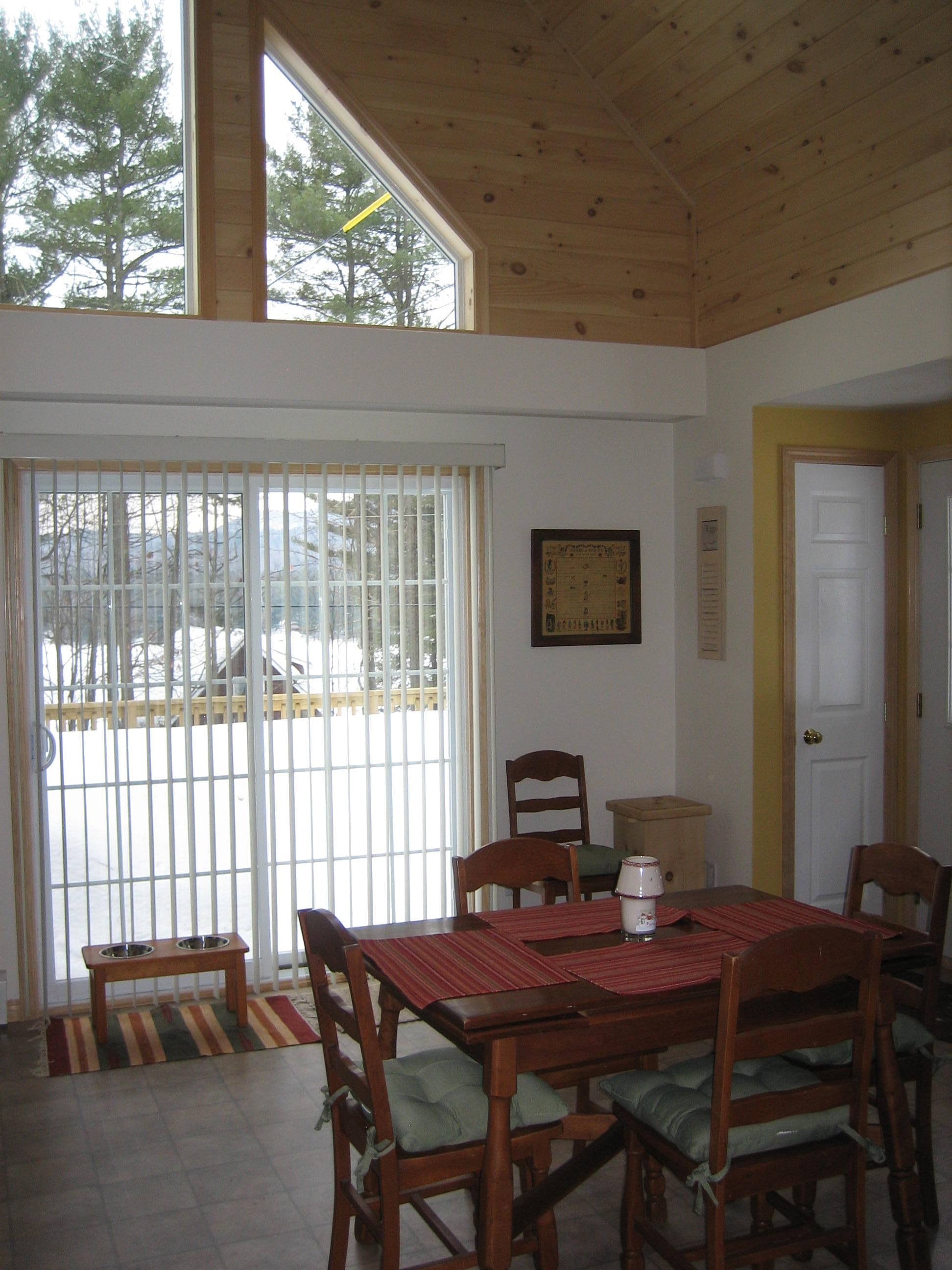Thompson dining room with wood ceiling and large windows